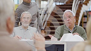 Groups of senior people disputing during class in library