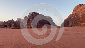 Groups of tourist on safari tour stop to watch sunset from viewpoint in Wadi Rum desert in Jordan