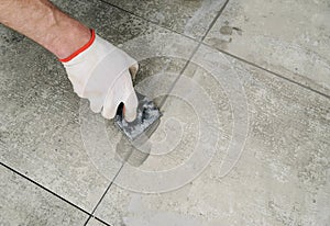 Grouting ceramic tiles.