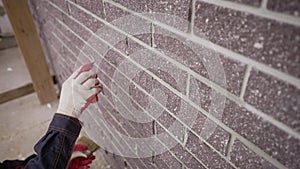 Grouting seams on the facade of the building with a trowel. Plasterers repair the facade of the house. Sealing the seams