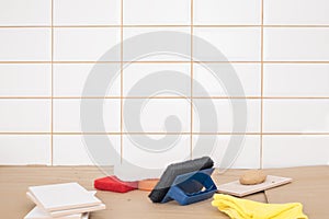 Grouting tools on white ceramic tile wall