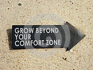 Grow beyond your comfort zone sign on the arrow.