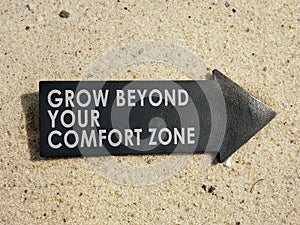 Grow beyond your comfort zone sign on the arrow. photo