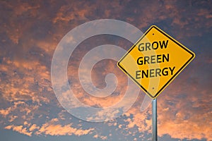 `GROW GREEN ENERGY` ROAD SIGN AGAINST SUNSET CLOUDS