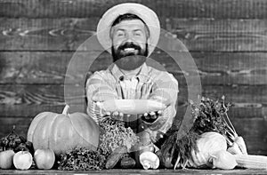 Grow organic crops. Farmer straw hat presenting fresh vegetables. Man cheerful bearded farmer hold corncob or maize