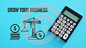 Grow your business is shown using the text and pictures of coins and construction crane