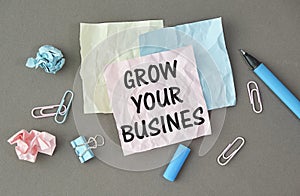 Grow your business words on office table with computer, coffee, notepad, smartphone