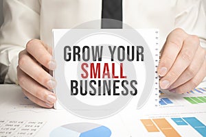 Grow Your Small Business. text on paper on craft envelope on white background