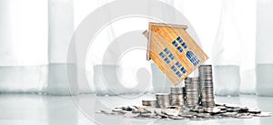 Growing coins  house on stack coins. Concept of Investment propert