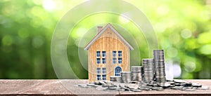 Growing coins  house on stack coins. Concept of Investment propert