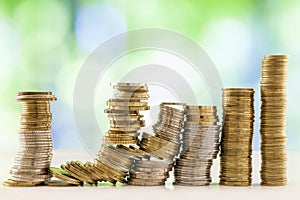 Growing coins stacks with green and blue sparkling bokeh background. Financial growth, saving money, business finance wealth and