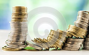 Growing coins stacks with green and blue sparkling bokeh background. Financial growth, saving money, business finance wealth and