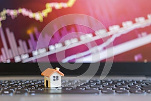 Growing home sale grap. model of the house on the background of growth graph. The concept of rising property prices