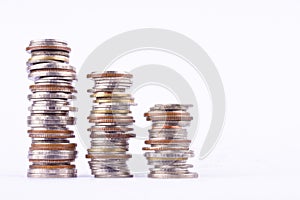 Growing money graph on a row of coin and pile of bath coins stack on white background finance business isolated