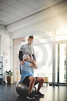 Growing old doesnt have to be a pain. a young male physiotherapist assisting a senior patient in recovery.