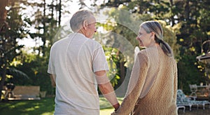 Growing old with you is my joy. a mature couple enjoying a walk in their yard.