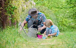 Growing plants. Take care of plants. Day of earth. Boy and father in nature. Gardening tools. Planting flowers. Dad