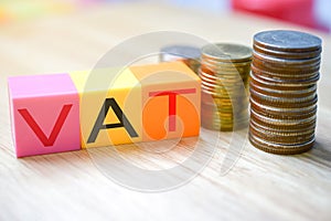 Growing taxes - colour blocks with VAT and money stacks