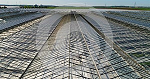 Growing vegetables in greenhouses. Large modern greenhouse. Flight over a large greenhouse. greenhouses aerial view