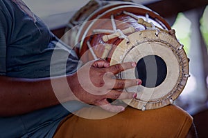 Grown man playing dolak drum, traditional percussion instrument, player, drummer