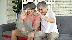 Grown son teaching senior Father Use laptop online social media At Home