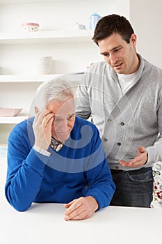 Grown Up Son Consoling Senior Parent