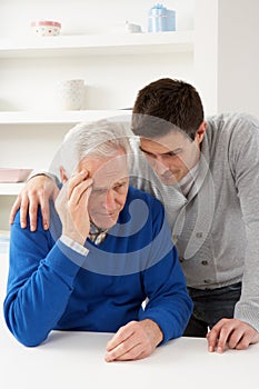 Grown Up Son Consoling Senior Parent photo