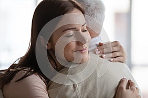 Grownup daughter hug retired old dad enjoy being child