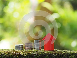 Growth coin stack with red house model. Savings budget plan for house. Investment mortgage fund finance property, home loan