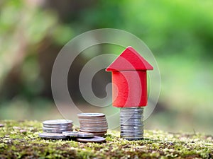 Growth coin stack with red house model. Savings budget plan for house. Investment mortgage fund finance property, home loan