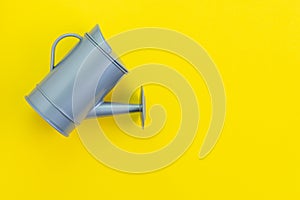 Growth idea, grow or investment profit concept, small gray watering can on yellow background with copy space