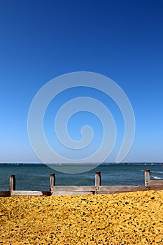 A groyne on west Wittering beach on a sunny day.