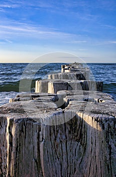 Groynes jut into the horizon in the Baltic Sea. Breakwater at the sea