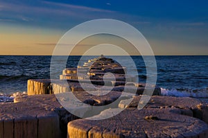 Groynes jut into the horizon in the Baltic Sea. Breakwater at the sea