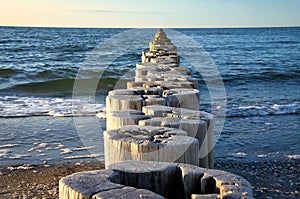 Groynes jut into the horizon in the Baltic Sea. Breakwater at the sea