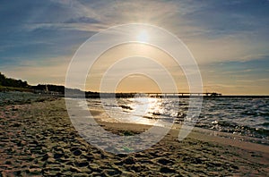 Groynes jut into the sea at sunset. The sun shines on the Baltic Sea. Landscape