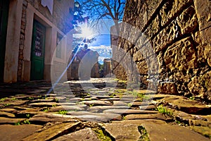 Groznjan cobbled street and old architecture at sunset view