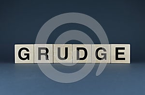 Grudge. Cubes form the word Grudge