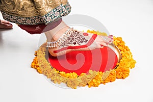 Gruha Pravesh / Gruhapravesh / Griha Pravesh, closeup picture of right feet of a Newly married Indian Hindu bride dipping her fit