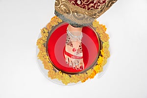 Gruha Pravesh / Gruhapravesh / Griha Pravesh, closeup picture of right feet of a Newly married Indian Hindu bride dipping her fit