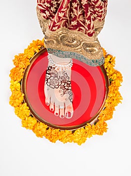Gruha Pravesh / Gruhapravesh / Griha Pravesh, closeup picture of right feet of a Newly married Indian Hindu bride dipping her fit