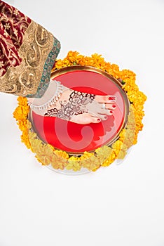 Gruha Pravesh / Gruhapravesh / Griha Pravesh, closeup picture of right feet of a Newly married Indian Hindu bride dipping her fit