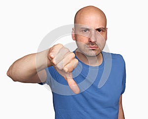 Grumpy bald man gesturing his thumb down