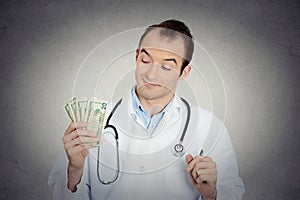 Grumpy greedy miserly health care professional holding money