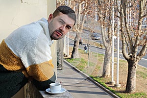 Grumpy looking man drinking his morning coffee
