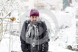 Grumpy man in a snowy garden