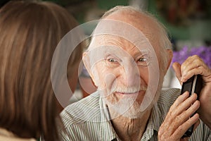 Grumpy senior couple with telephone