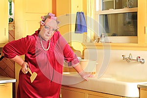 Grumpy Senior Lady Holding Fly Swatter