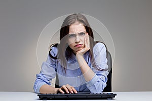 Grumpy woman using keyboard