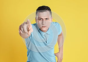 Grumpy young man posing on background